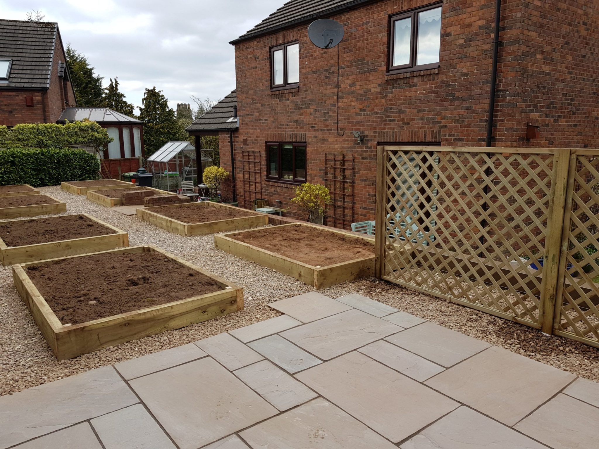 stone patio and wooden planters we landscaped in Brampton Cumbria