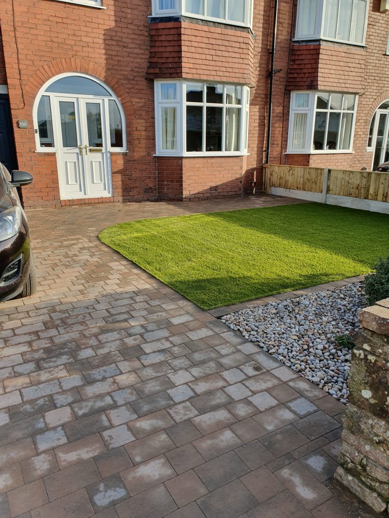 Block paving drive with artificial grass by Carlisle Landcsapers Landform Landscaping ltd