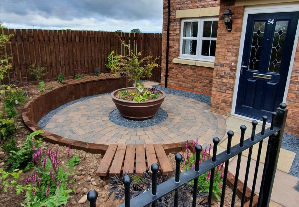 circular patio and ceramic pot with Acer centre