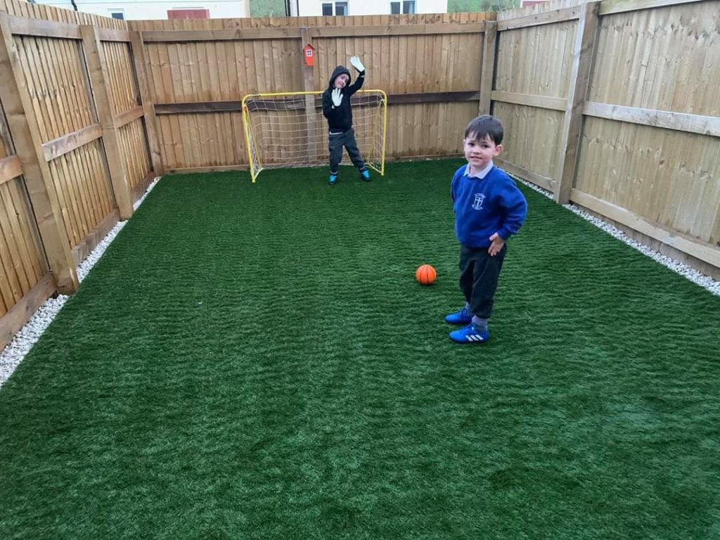 children playing football on artificial lawn in carlisle