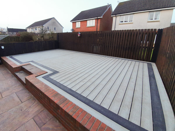 garden with light grey composite deck and charcoal picture frame detail